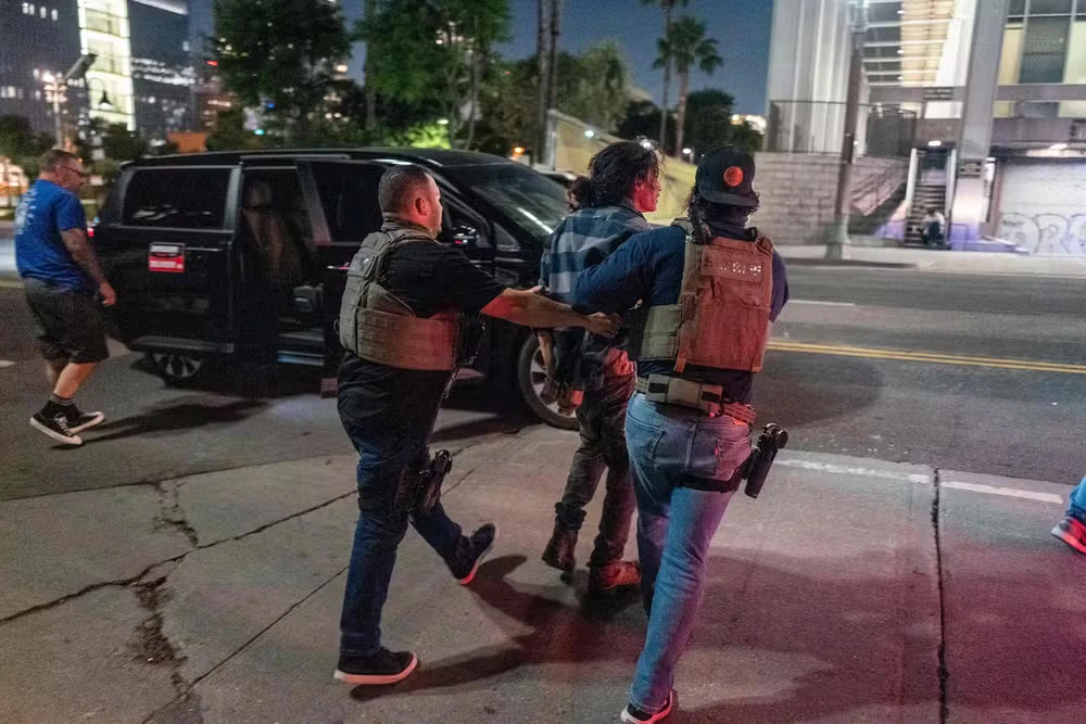 111367280-law-enforcement-officers-arrest-a-man-as-a-curfew-is-in-effect-following-days-of-protests