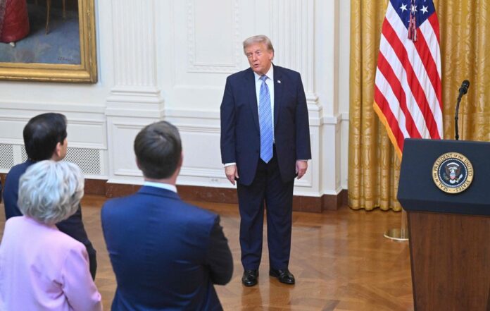115682556-us-president-donald-trump-stands-next-to-the-lectern-after-delivering-an-address-to-the-na