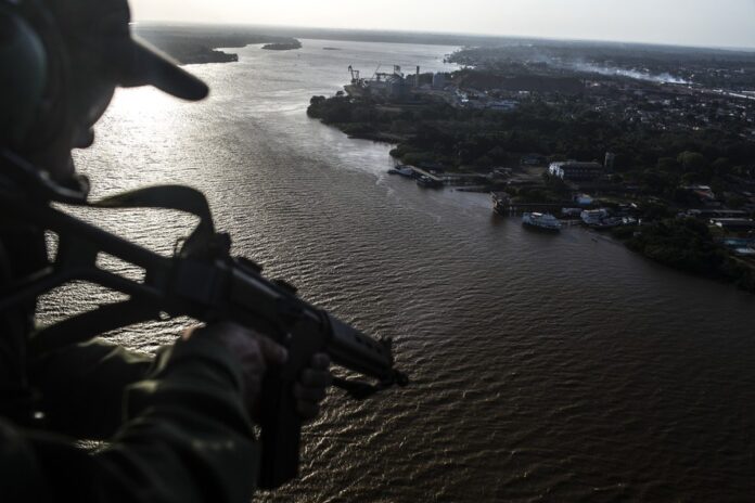 111713809-an-aerial-tactical-group-soldier-patrols-a-canal-near-the-santana-port-in-brazil-oct-2 (1)